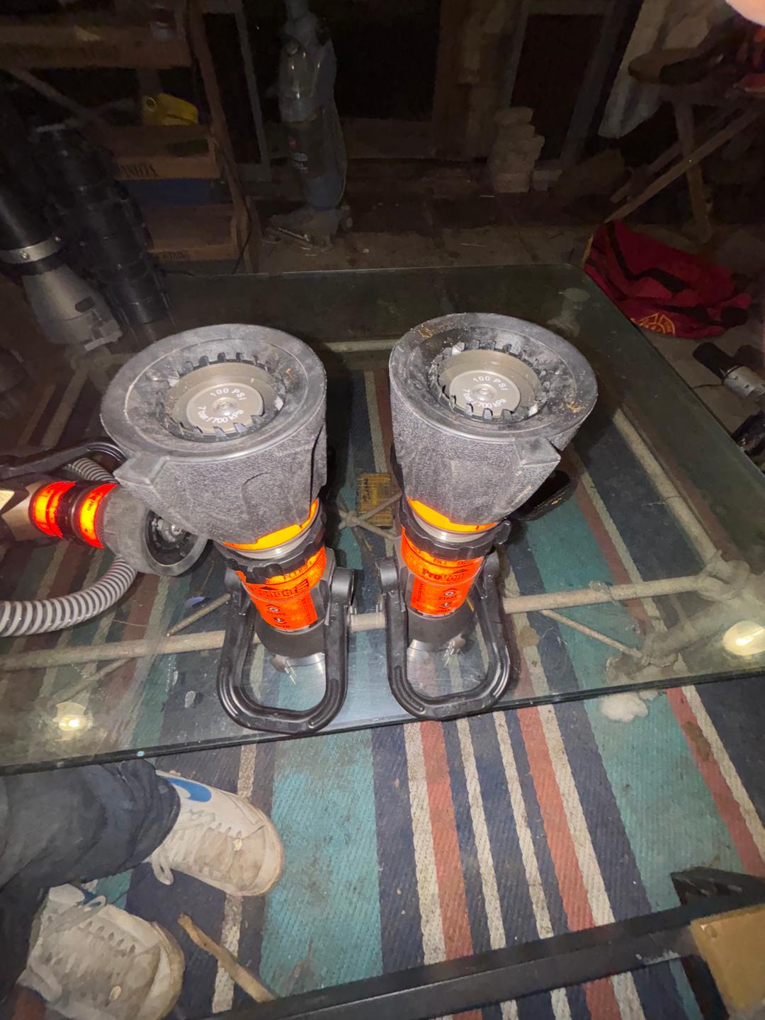 Spreader and rams with fire hose nozzles 