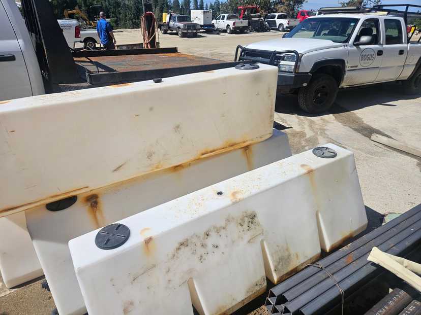 Four 100 gallon plastic saddle tanks -
